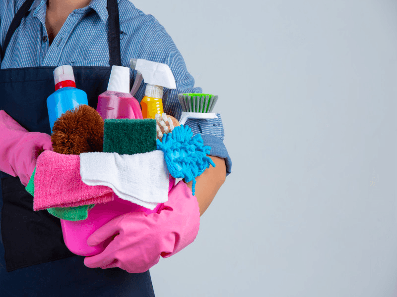 a maid with cleaning supplies